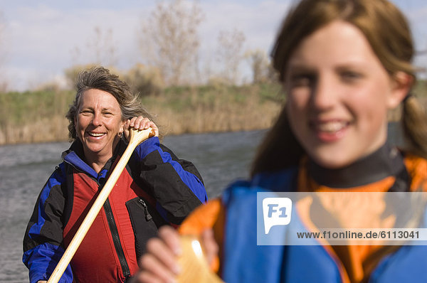 A mother and daughter canoeing