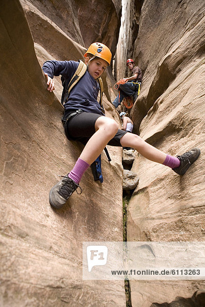 Young girl exploring a slot canyon.
