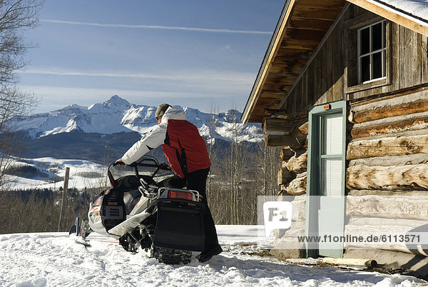 Man loading snowmobile.