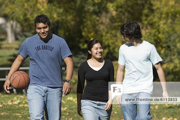 Three teenagers walking in a park in Fort Collins  Colorado.