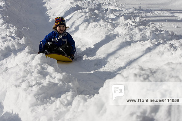 A young girl sledding  Newry  Maine.