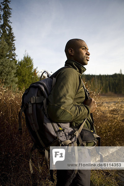 African ethnicity male hiker with backpack.