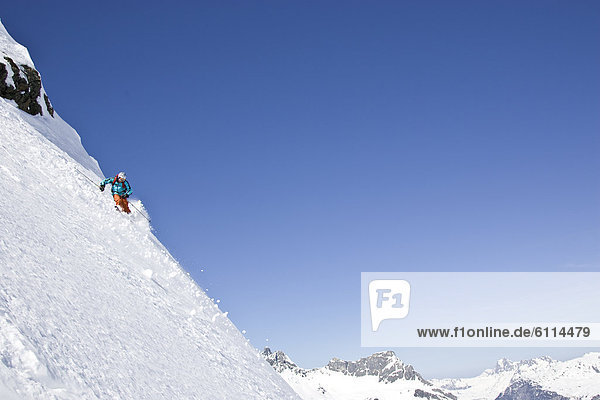 A young man skis untracked powder off-piste at St. Anton am Arlberg  Austria.