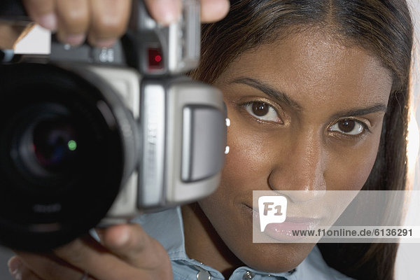 Close up of woman holding camera