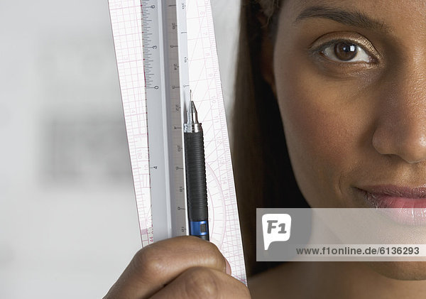 Close up of woman holding ruler and pencil