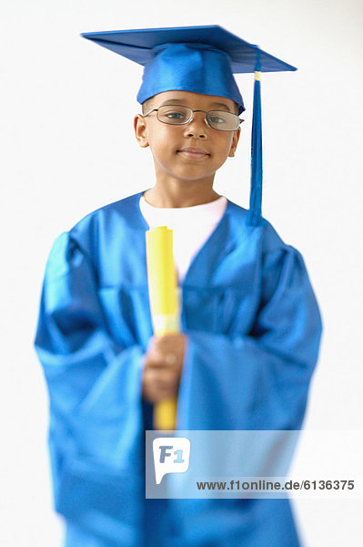 Little boy wearing cap and gown