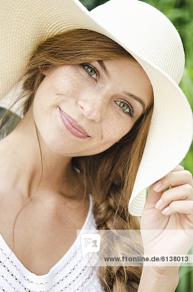 Smiling young woman wearing sunhat  portrait