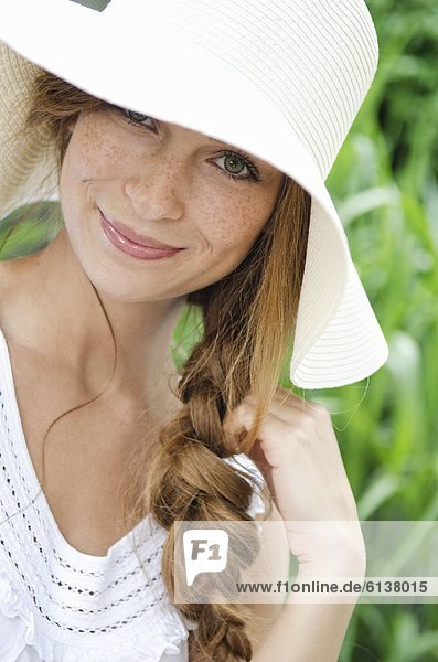 Smiling young woman wearing sunhat  portrait