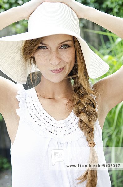 Smiling young woman wearing sunhat  portrait