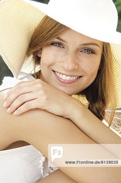 Smiling young woman wearing sunhat  portrait