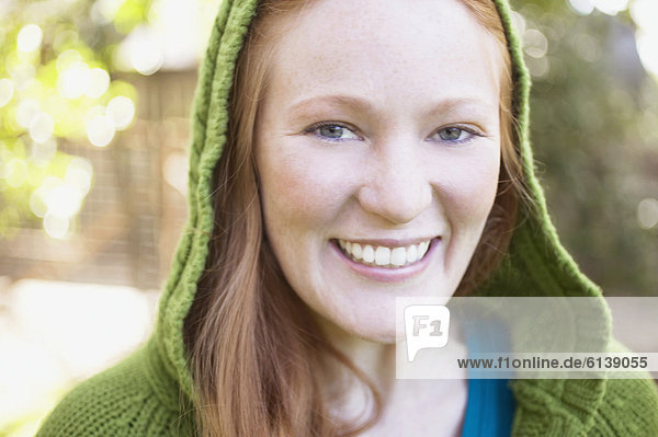 Close up of a young woman in green hood