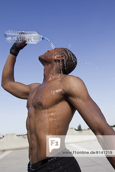 Athlete pouring water on himself