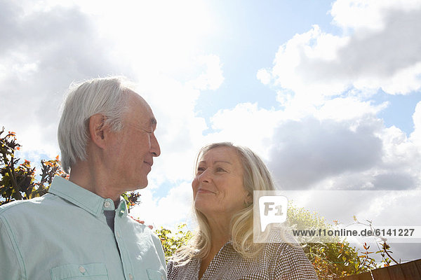 Older couple standing outside together