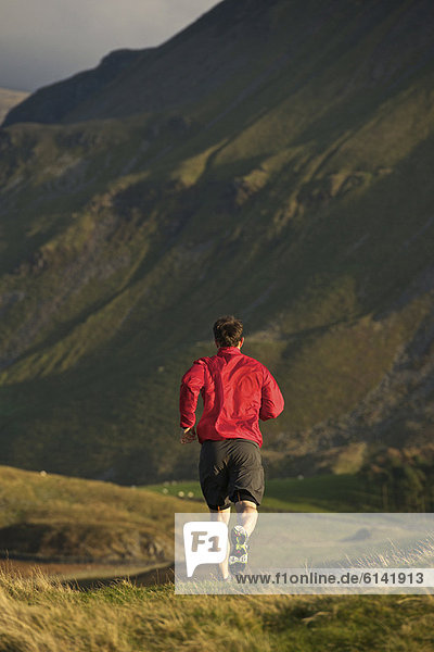 Man running on rural mountain road
