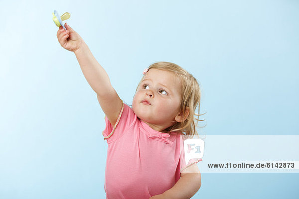 Girl holding pacifier