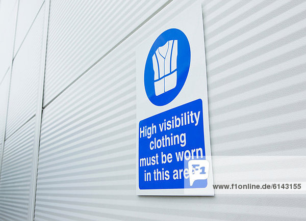 High visibility clothing sign on warehouse door