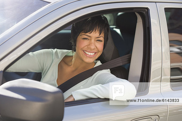Portrait of woman sitting inside car