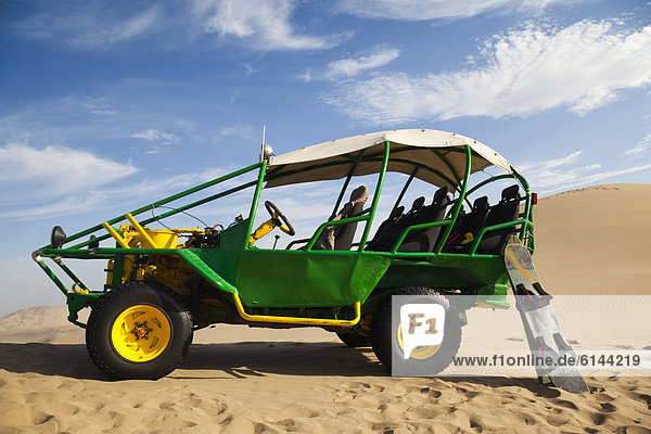 Dune buggy with boards for sandboarding in the desert near Huacachina  Ica Region  Peru  South America