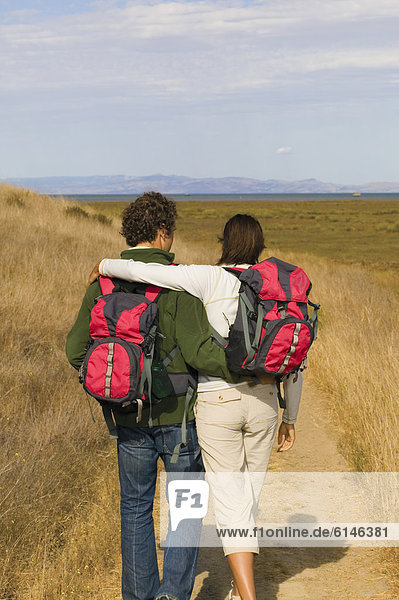 Rear view of couple hiking
