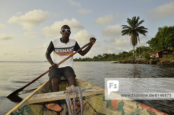 Local man wearing a Germany t-shirt on a boat trip to LobÈ Waterfall  near Kribi  Cameroon  Central Africa  Africa