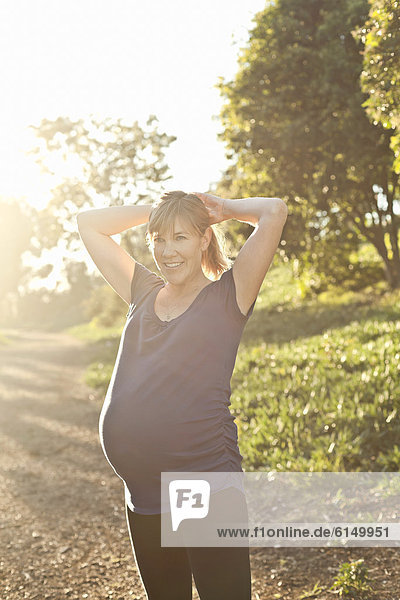 Pregnant Caucasian woman exercising outdoors