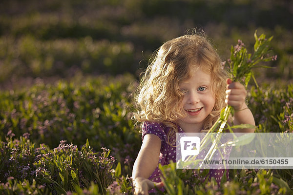 Caucasian girl picking flowers