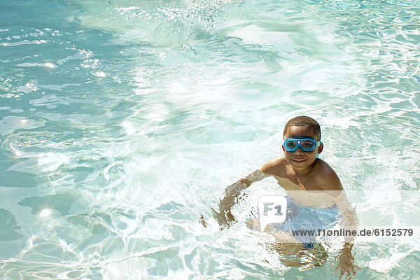 African American boy swimming in swimming pool