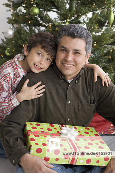 Hispanic father and son on Christmas