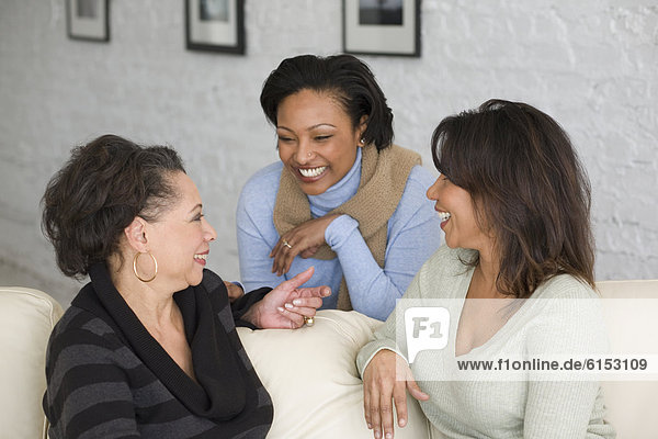 African mother and adult daughters talking