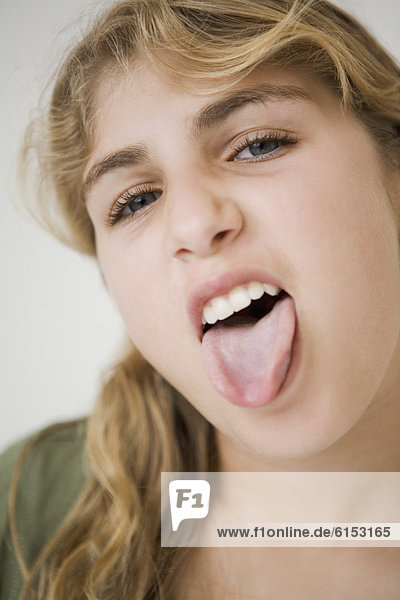 Close up of girl sticking out tongue