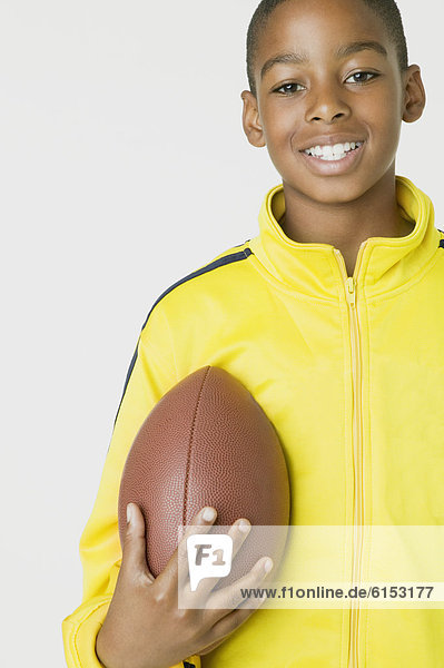 African boy holding football