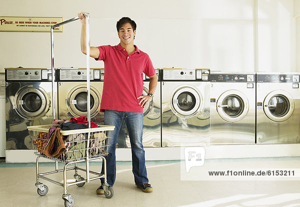 Asian man in laundromat