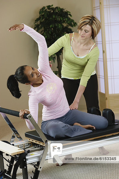 Indian woman exercising with personal trainer