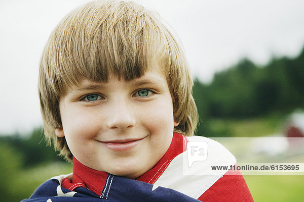 Boy wrapped in American flag