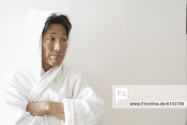 Asian man wearing bathrobe