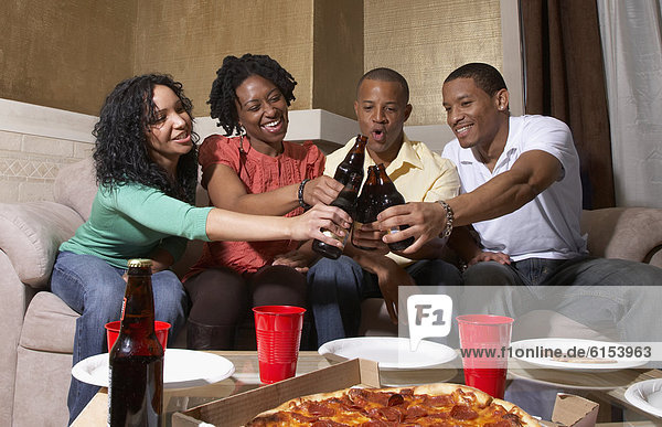 Multi-ethnic friends having pizza party