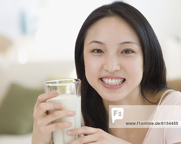Asian woman drinking milk
