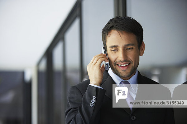 South American businessman talking on cell phone
