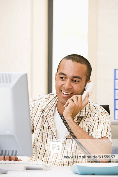 Young businessman talking on telephone