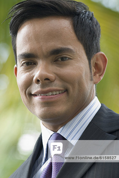 Close up of Hispanic businessman smiling