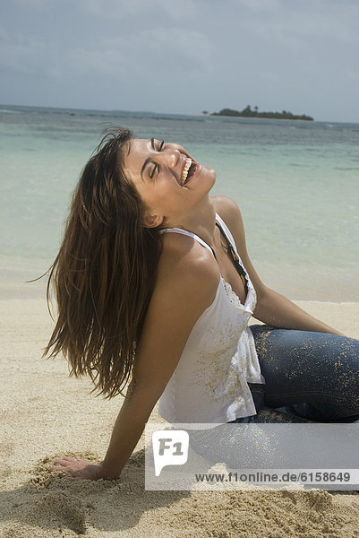 Woman laughing at beach