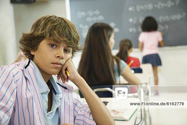 Boy at desk in classroom
