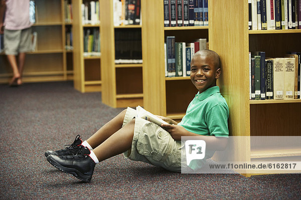 African American boy holding library book
