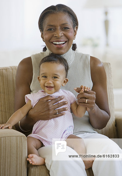 African American grandmother holding baby