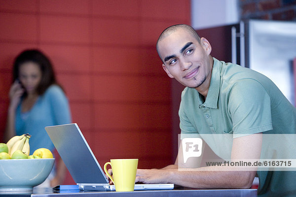 African American man typing on laptop