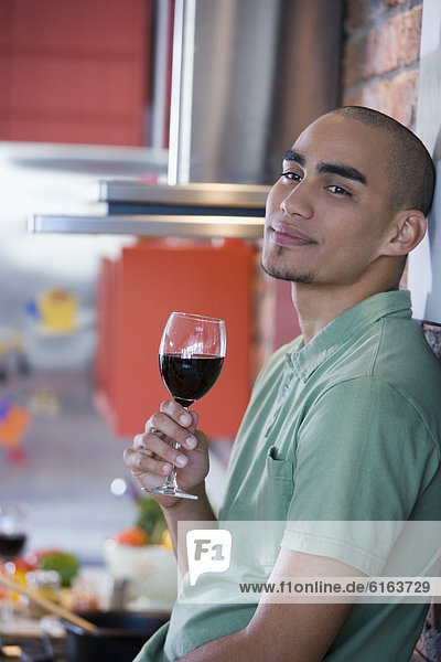 African American man drinking wine