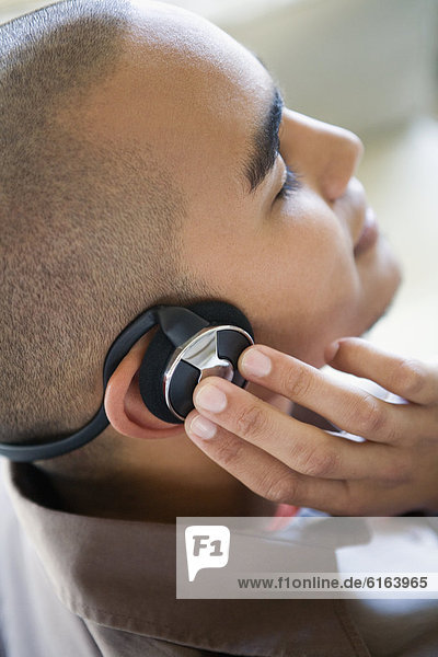 African American man listening to headphones