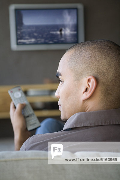 African American man watching television