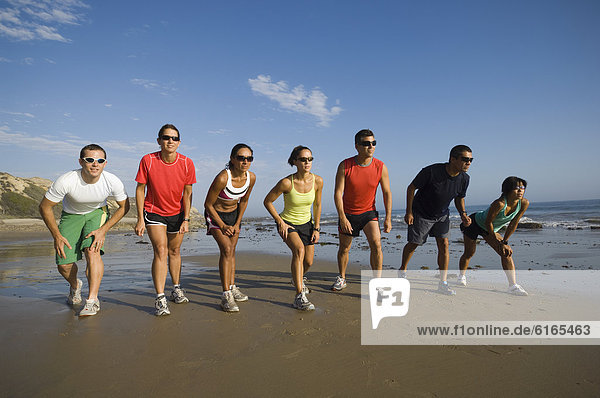 Wettrennen Rennen Strand Läufer multikulturell