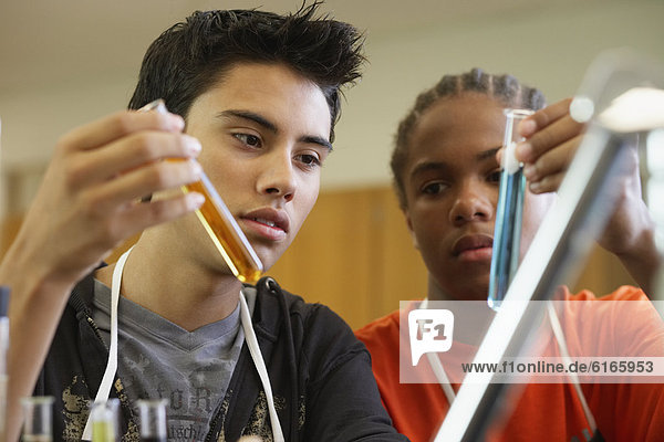 Multi-ethnic teenaged boys in science class